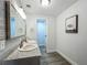 Bathroom featuring a double vanity with granite countertop and modern fixtures at 1118 Ne 17Th Ave, Ocala, FL 34470