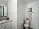 Stylish bathroom featuring granite counters, framed mirror and modern fixtures at 1118 Ne 17Th Ave, Ocala, FL 34470