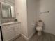 Half bath with granite countertop and updated wood-look flooring in bathroom at 1118 Ne 17Th Ave, Ocala, FL 34470