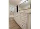 Bathroom with updated double sink vanity and step-in shower with tiled walls at 1118 Ne 17Th Ave, Ocala, FL 34470