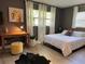 Bedroom with modern finishes, wood-look floors, and natural light from large window at 1118 Ne 17Th Ave, Ocala, FL 34470