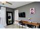 Stylish bedroom with a modern desk area, large mirror, and neutral decor at 1118 Ne 17Th Ave, Ocala, FL 34470