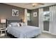Comfortable bedroom with blue bedding, soft lighting, and playful dog-themed artwork at 1118 Ne 17Th Ave, Ocala, FL 34470