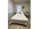 Cozy bedroom features a comfortable queen-size bed, and bright natural light through the windows at 1118 Ne 17Th Ave, Ocala, FL 34470