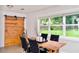 Cozy dining room featuring a wooden table, black chairs, and a sliding barn door at 1118 Ne 17Th Ave, Ocala, FL 34470