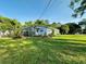 View of the house showing its manicured lawn and surroundings, complemented by well-maintained landscaping at 1118 Ne 17Th Ave, Ocala, FL 34470