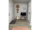 Hallway entrance with laminate flooring, accent decor, and views of multiple doorways at 1118 Ne 17Th Ave, Ocala, FL 34470