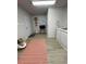 Hallway entrance with laminate flooring, accent decor, and views of multiple doorways at 1118 Ne 17Th Ave, Ocala, FL 34470