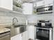Well-lit, updated kitchen with stainless steel appliances, bright white cabinets, and granite countertops at 1118 Ne 17Th Ave, Ocala, FL 34470