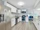 Bright, updated kitchen with white cabinets, stainless steel appliances, wood-look flooring, and granite countertops at 1118 Ne 17Th Ave, Ocala, FL 34470