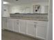 Spacious kitchen featuring sleek white cabinetry, granite countertops, modern hardware, and stylish backsplash at 1118 Ne 17Th Ave, Ocala, FL 34470