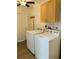 Functional laundry room with appliances, wood cabinets, and ample storage at 1118 Ne 17Th Ave, Ocala, FL 34470