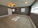Bright living room features lots of light, ceiling fan, and wood-look flooring at 1118 Ne 17Th Ave, Ocala, FL 34470