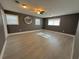 Bright living room features lots of light, ceiling fan, and wood-look flooring at 1118 Ne 17Th Ave, Ocala, FL 34470