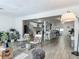 Open concept view from the living room to the kitchen, with wood-look floors and lots of natural light at 1118 Ne 17Th Ave, Ocala, FL 34470