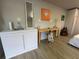 Living space with a wash basin, desk, and wood laminate flooring; artwork on the wall at 1118 Ne 17Th Ave, Ocala, FL 34470