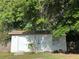 Exterior of outbuilding featuring a white door and small landscaping at 1118 Ne 17Th Ave, Ocala, FL 34470