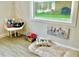 Cozy pet room with dog bed, hanging chair, toys, and whimsical dog-themed artwork at 1118 Ne 17Th Ave, Ocala, FL 34470