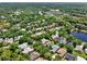Aerial view of the community showcasing lush landscaping and nearby lakes at 112 Overton Gardens Lane, Deland, FL 32724
