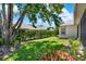 Well-maintained backyard with lush green lawn and mature landscaping at 112 Overton Gardens Lane, Deland, FL 32724