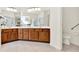 Bright bathroom featuring dual sinks, wood cabinets, and a large mirror at 112 Overton Gardens Lane, Deland, FL 32724