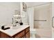 Well-lit bathroom with a single sink vanity and shower-tub combo at 112 Overton Gardens Lane, Deland, FL 32724
