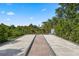 Bocce ball courts nestled in a landscape with greenery and a nearby shed at 112 Overton Gardens Lane, Deland, FL 32724