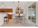 Charming dining area with modern chandelier and access to the outdoor patio at 112 Overton Gardens Lane, Deland, FL 32724