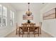 Elegant dining room featuring a wooden table with upholstered chairs and a decorative chandelier at 112 Overton Gardens Lane, Deland, FL 32724