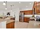 Kitchen showcases stainless steel appliances, wooden cabinetry, and ample counter space at 112 Overton Gardens Lane, Deland, FL 32724