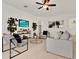 Well-lit living room boasting stylish furniture, a ceiling fan, and a mounted television at 112 Overton Gardens Lane, Deland, FL 32724