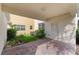 Cozy covered back patio features brick pavers, offering a private outdoor space for relaxation and leisure at 11386 Biography Way, Orlando, FL 32832
