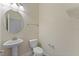 Powder room features a pedestal sink, neutral walls, and sleek fixtures, creating a functional and clean space at 11386 Biography Way, Orlando, FL 32832