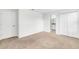A carpeted bedroom with white walls and trim, featuring a closet and bathroom access at 11386 Biography Way, Orlando, FL 32832