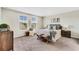 Bright bedroom with two large windows, stylish decor, and comfortable furnishings at 11386 Biography Way, Orlando, FL 32832