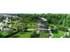 Aerial view of community park with watch tower, green spaces, and winding pathways at 11386 Biography Way, Orlando, FL 32832