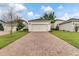 Long brick driveway leads to a detached two-car garage at 11386 Biography Way, Orlando, FL 32832