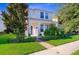 Charming two-story home with manicured lawn, bushes, front walkway, and a covered entryway supported by columns at 11386 Biography Way, Orlando, FL 32832