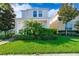 Well-maintained front yard with lush green lawn, colorful bushes and landscaped garden beds at this lovely two-story home at 11386 Biography Way, Orlando, FL 32832
