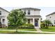 Charming two-story home features a well-manicured lawn and colorful landscaping at 11386 Biography Way, Orlando, FL 32832