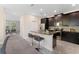 Open kitchen featuring dark wood cabinets, granite countertops, stainless steel appliances, and bar seating at 11386 Biography Way, Orlando, FL 32832