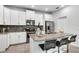 Bright modern kitchen with a granite island, stainless appliances, and white cabinets at 11386 Biography Way, Orlando, FL 32832