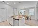 Bright open kitchen with a granite island and a view of the dining area at 11386 Biography Way, Orlando, FL 32832