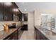 Modern kitchen showcasing dark cabinetry, stainless steel appliances, mosaic backsplash, and granite countertops at 11386 Biography Way, Orlando, FL 32832
