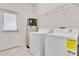Well-lit laundry room with modern washer, dryer, and ample storage at 11386 Biography Way, Orlando, FL 32832