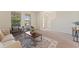 Inviting living room featuring neutral walls, carpet flooring, stylish furniture, and a decorative rug at 11386 Biography Way, Orlando, FL 32832