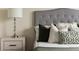 Comfortable main bedroom showcasing stylish decor with an upholstered headboard and plush pillows at 11386 Biography Way, Orlando, FL 32832