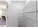 Walk-in pantry featuring multiple wire shelves and a view to an adjacent room at 11386 Biography Way, Orlando, FL 32832
