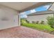 Covered patio area with brick flooring, perfect for outdoor relaxing at 11386 Biography Way, Orlando, FL 32832
