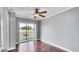 Comfortable bedroom with wood floors, ceiling fan, and sliding glass doors to balcony at 115 Oyster Bay Cir # 260, Altamonte Springs, FL 32701